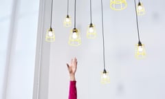 A hand reaching for lightbulbs