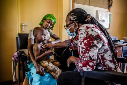 A health worker checks a child’s pulse during trials for a new malaria vaccine in Kilifi County, Kenya, 19 May 2022.