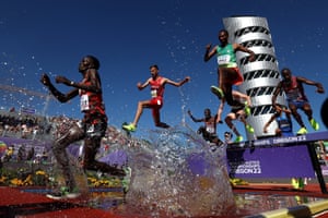 Soufiane El Bakkali of Team Morocco and Getnet Wale of Ethiopia navigate the water in the 3,000m steeplechase.