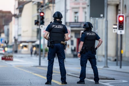 Police officers patrol a street in downtown Aarau on Sunday