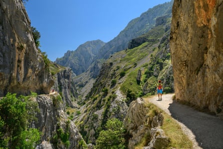 A woman on a spectacular path in a gorge in hot weather
