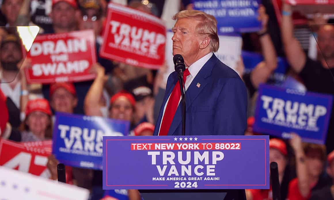 Donald Trump on a podium with the words ‘Trump Vance. Make America Great Again. 20204’.