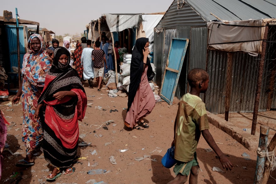 People walk through the weekly market in Mbera camp in Bassikounou