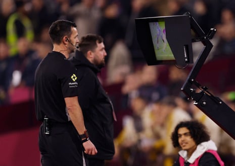 Referee Andrew Madley checks the VAR monitor before awarding a penalty to West Ham.