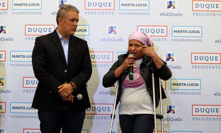 Iván Duque listens to the testimony of Sara Morales of the Rosa Blanca Corporation, an organisation made up of women who were recruited by the Farc, in Bogotá on Friday.