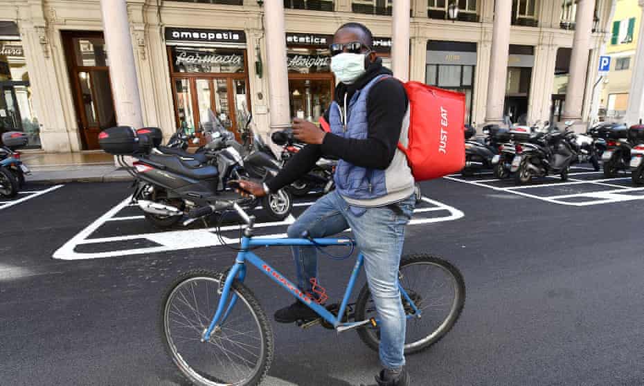 A delivery rider in Genoa, Italy, 19 March 2020: ‘Uniting against the pandemic in a show of spontaneous patriotism ultimately makes the nation more cohesive.’