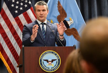 The US secretary of defense, Pete Hegseth, speaks during a press conference in front of the US national flag