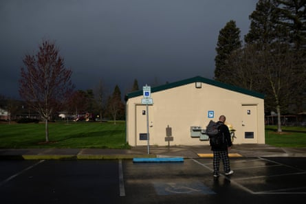person walks towards a low white building