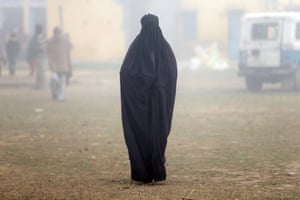 Uttar Pradesh, India
A woman wearing a burka leaves a polling booth after voting during the state assembly election in Deoband.