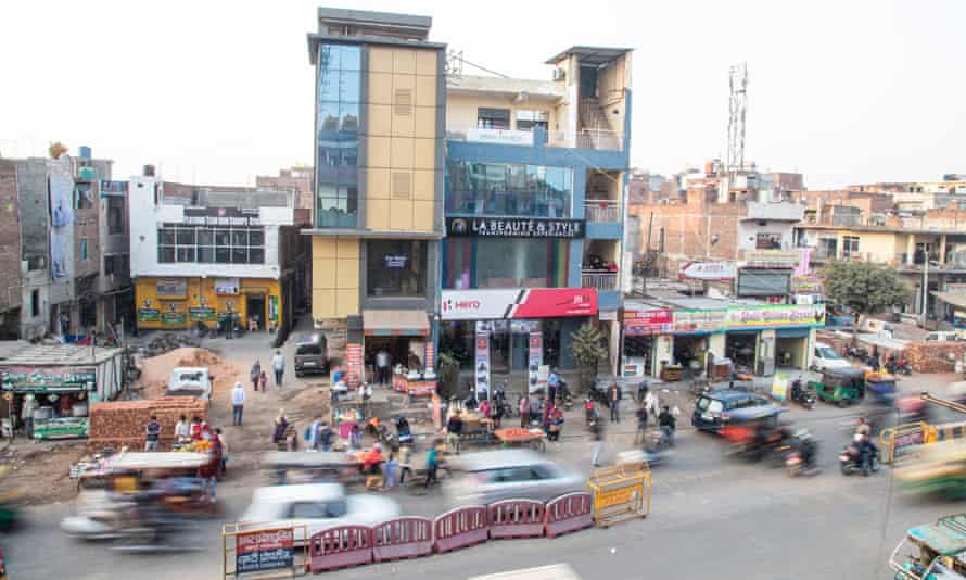 A streetscene with crowds on foot and traffic