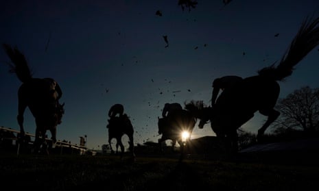 A general view as horses land over a fence at Plumpton Racecourse