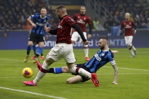 Inter Milan’s Marcelo Brozovic, right, clears the ball to corner ahead of AC Milan’s Ante Rebic.