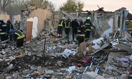 Emergency personnel clear debris as they search for victims of the strike.