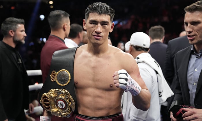 Dmitry Bivol poses with his WBA light-heavyweight belt after the fight