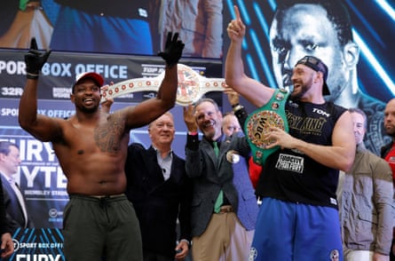 Dillian Whyte and Tyson Fury dance together on stage immediately after the weigh-in ahead of the WBC World Heavyweight title fight between Tyson Fury and Dillian Whyte fight.