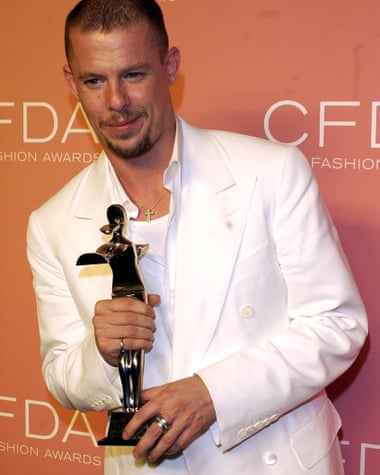 Alexander McQueen holds statuette at awards ceremony