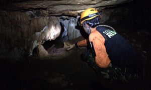 Thai rescue officers search for alternative entrances during the rescue operation for missing football players in Tham Luang cave.