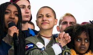 Emma Gonzalez (centre), a survivor of the school shooting at Marjory Stoneman Douglas High School, cheers at the conclusion of the March For Our Lives in Washington, DC.