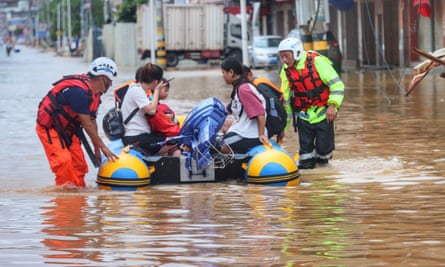 Flood-stranded people are rescued by a civilian rescue team with a rubber boat in Quanzhou, Fujian province