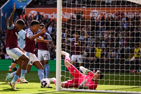 Aston Villa’s Ollie Watkins (second) header is pushed onto the post by Brentford’s keeper Mark Flekken and Leon Bailey follows up to stick the ball in the net.