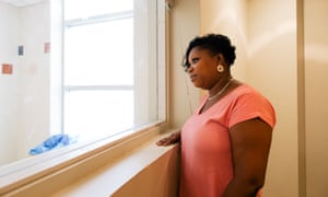 Nadia Bissette-Dolor, who works in the Office of the Chief Medical Examiner of New York City, stands by a window used by families to identify bodies of the deceased. She says family members rarely ask to view the body, but a small number do.