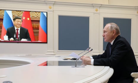 Vladimir Putin holds a video meeting with China’s Xi Jinping, at the Kremlin in Moscow on 30 December.
