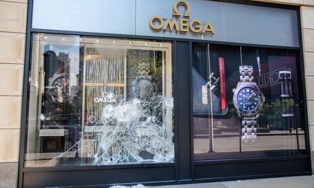 Broken windows are seen at an Omega following a night of civil unrest and looting in downtown Chicago.