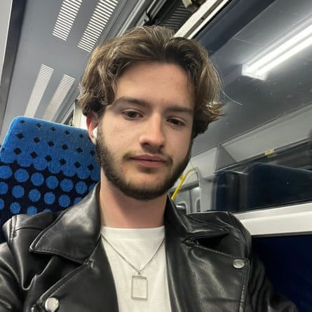 Brendan Cormac, 21: he is pictured sitting on a train on a seat with blue spotted upholstery. He wears a black biker-style jacket and white T-shirt with a chain and tag-style pendant around his neck, and has dark eyes, a short dark beard and lighter, wavy ear-length hair grown long on top.