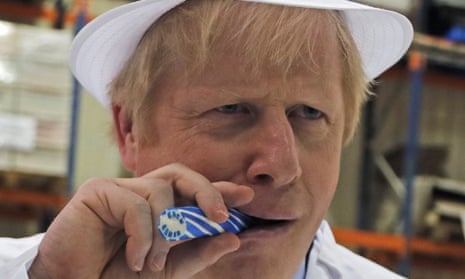 Boris Johnson eating a candy stick which reads “Back Boris” during a general election campaign trail stop at Coronation Candy in Blackpool.