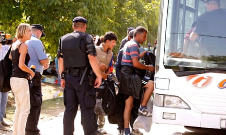 Refugees board buses transferring them to Hungary and Austria at the Croatian-Serbian border near Tovarnik, Croatia.