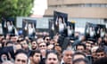 A crowd of men holding posters showing Ebrahim Raisi.