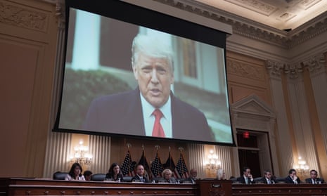 trump on screen over members of panel
