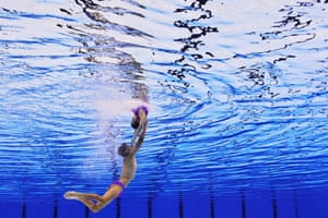 Two swimmers dance underwater