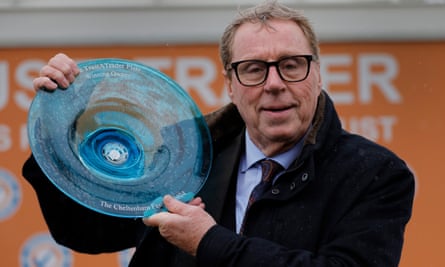Harry Redknapp celebrates with the winner’s trophy after his horse Shakem Up’Arry was victorious at the Cheltenham Festival.