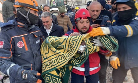 Two siblings, seven-month-old Omer and nine-year-old Muhammed Acar, are rescued in Adiyaman province, Turkey