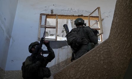 Two soldiers with weapons stand on some stairs