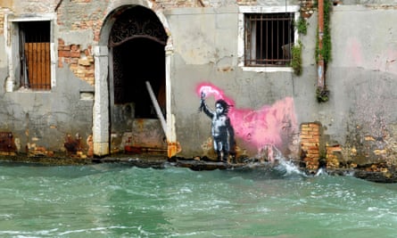 a migrant child wearing a lifejacket holding a pink flare