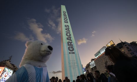 A man dressed as a bear takes part in a rally in support of the national team.