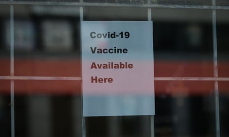 A sign advertising the availability of the Covid-19 is displayed on the front door of a pharmacy in Edmonton, Canada.