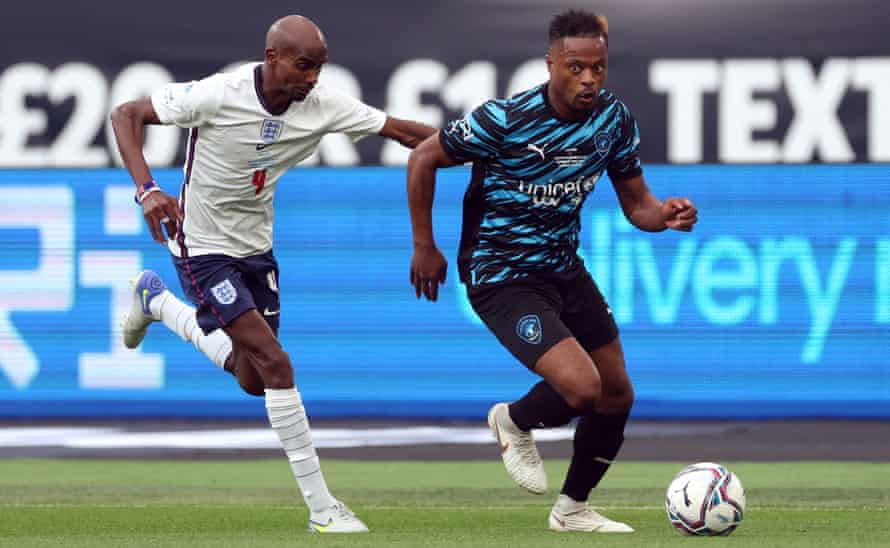 Patrice Evra tries to get the better of Mo Farah during Sunday's Soccer Aid match at the London Stadium