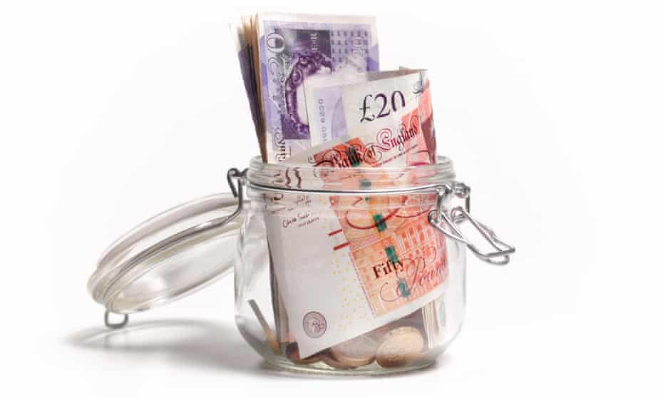 British £20 and £10 notes in savings jar