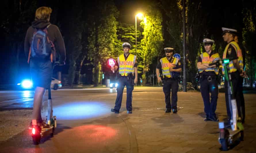 Police in Munich, one of many European cities to suffer a growing trend of ‘drink-riding’, stop an e-scooter user for a breath test.