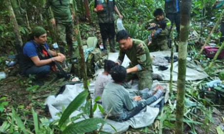 Colombian military personnel help four children who survived 40 days in the Amazon jungle after their plane crashed.