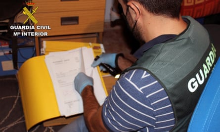A Guardia Civil officer examines files during the operation