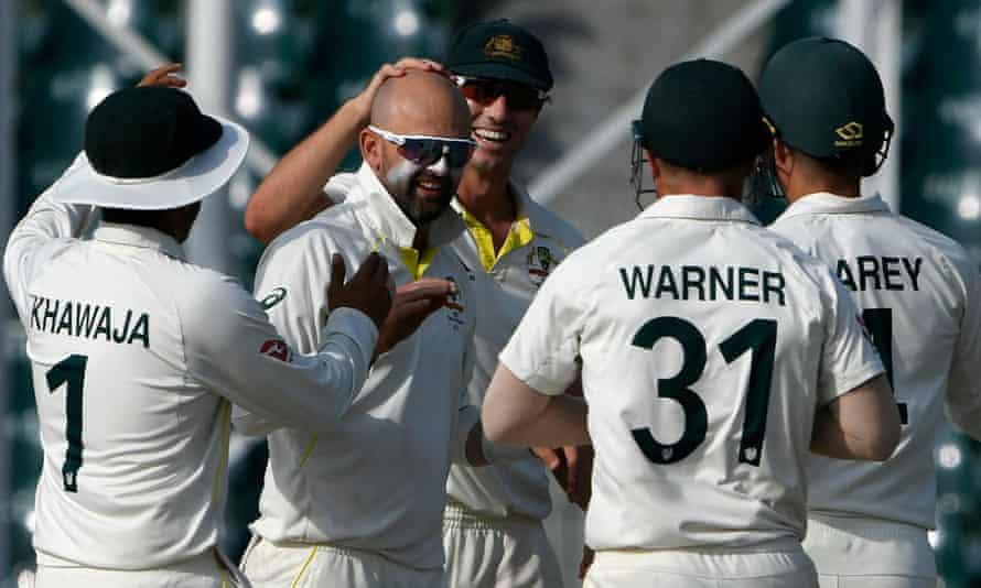 Nathan Lyon is congratulated after taking the wicket of Hasan Ali