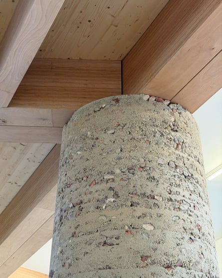 A rough concrete column meets wooden ceiling beams in Design Museum Ghent’s new wing