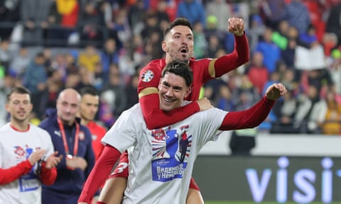 Dusan Vlahovic carries Filip Mladenovic as Serbia celebrate their Euro 2024 qualification after a draw with Bulgaria.