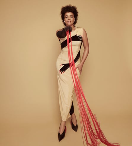 Lydia wears beige dress with pictures of arms, as if wrapped around her, shoes and gloves by loewe.com; earrings by shaunleane.com.