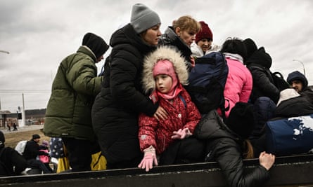 Residents evacuate the city of Irpin, northwest of Kyiv, during heavy shelling and bombing on 5 March