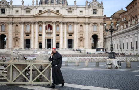 Cardinal Francois-Xavier Bustillo walks while talking on the phone in St Peter's Square, 9 May.